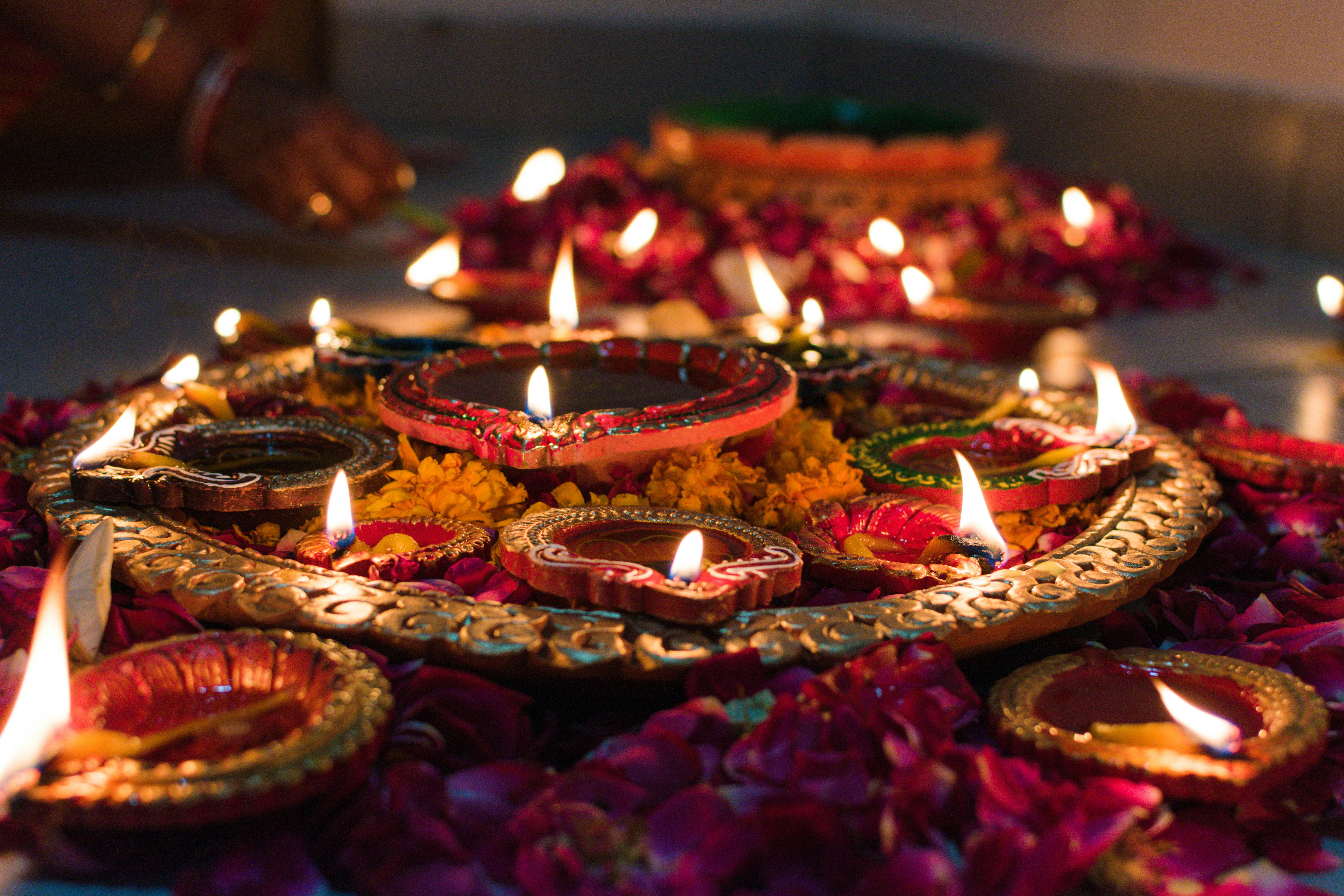 Family lighting diyas in the evening